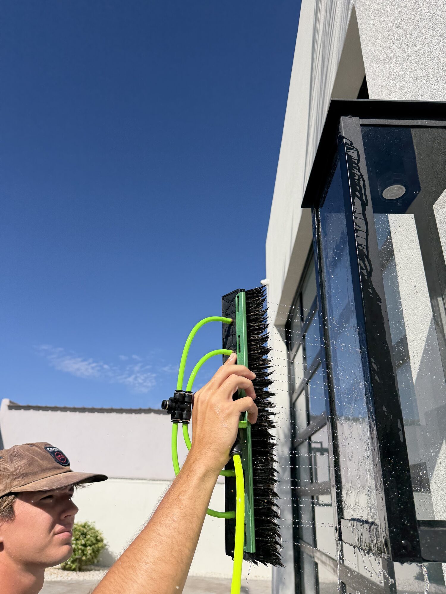 Water Fed Pole on a Wall of Glass